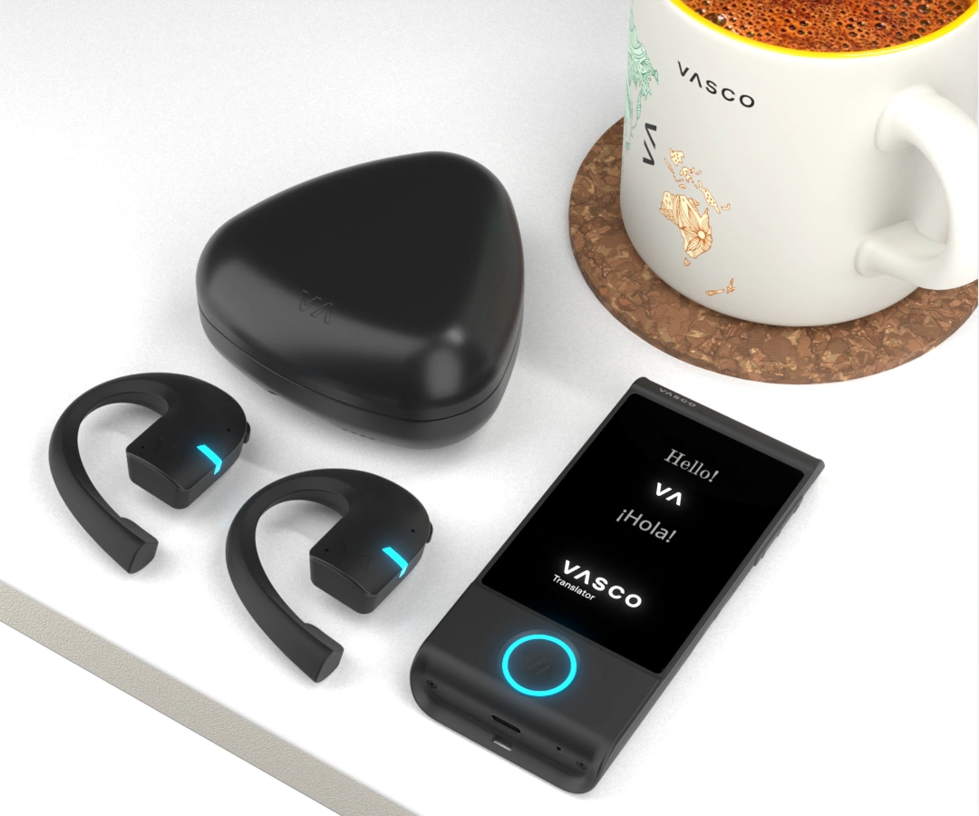 Vasco Translator E1 earbuds with charging case and a black Vasco Translator M4 lying on a white table.